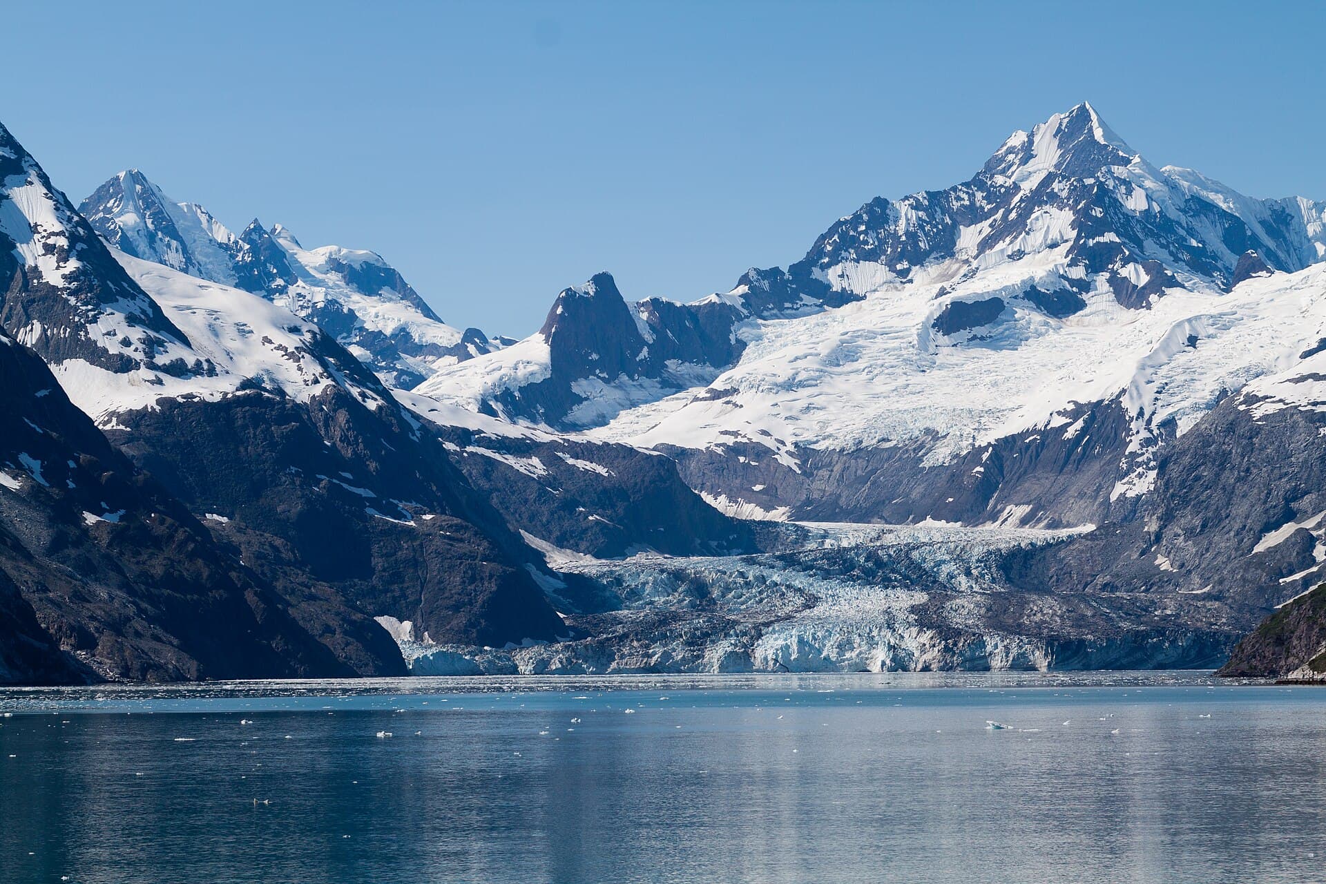 Johns Hopkins Glacier beneath a wall of snowy peaks